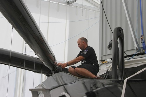 Tactician, Ray Davies, puts his electrical skills to good use working on the electronics fitout - Emirates Team NZ - Media Day January 17, 2012 © Richard Gladwell www.photosport.co.nz